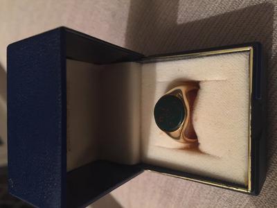 Gold ring with blue/green stone and red speckles