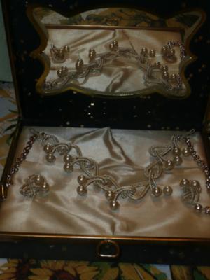 the necklace and earrings inside of box on display where there also is a mirror