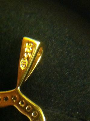 I have an "H" with another mark inside an oval on my gold plated 925